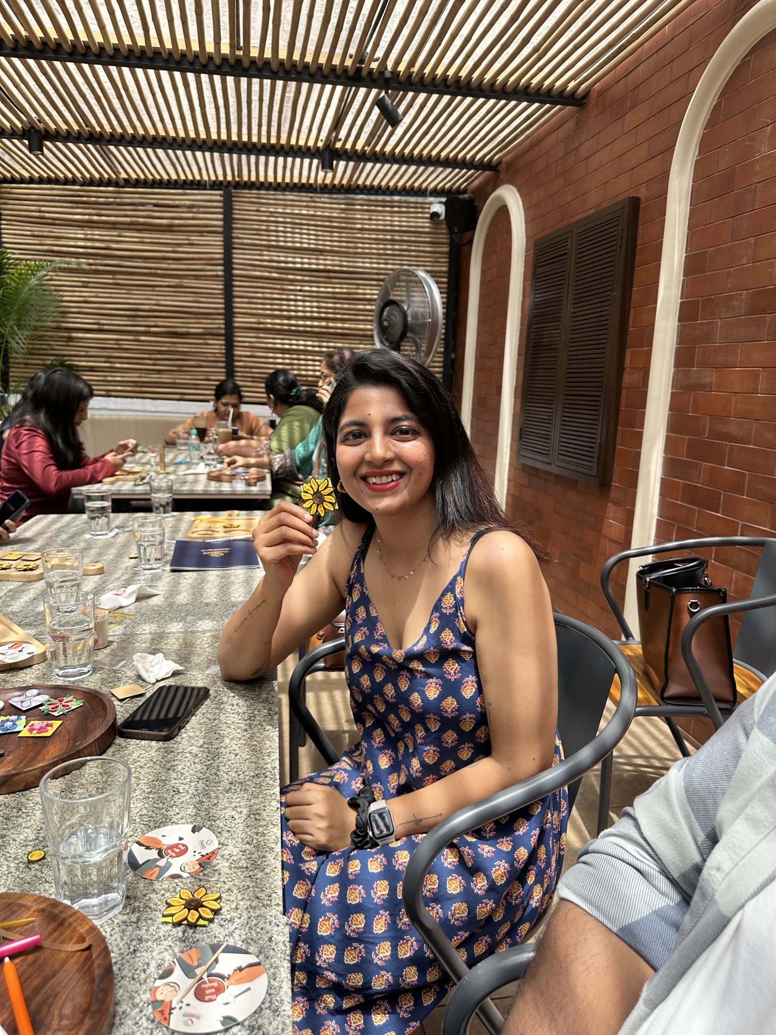 Guest showing off her handcrafted sunflower coaster