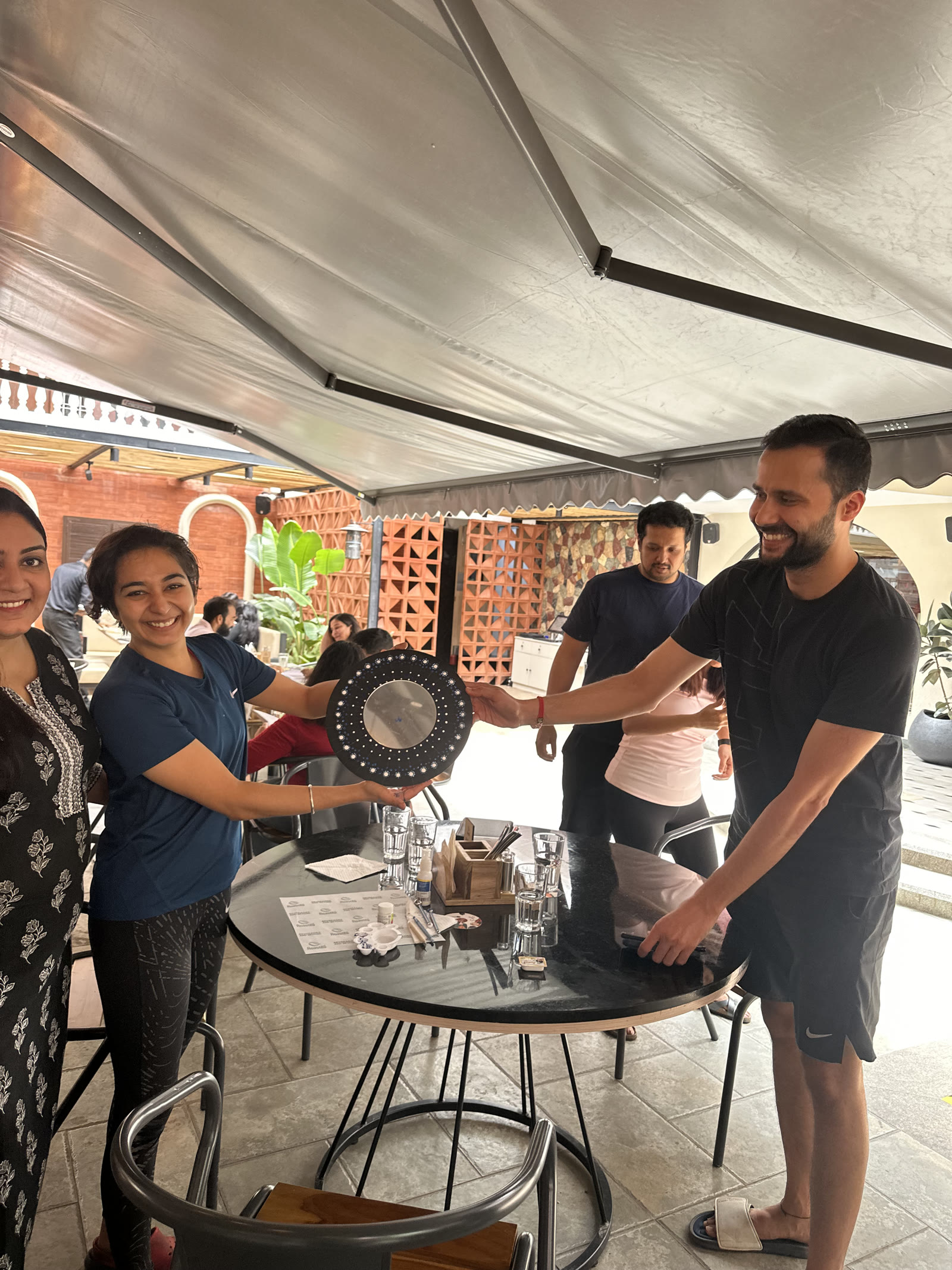 Guests presenting their finished decorative plate